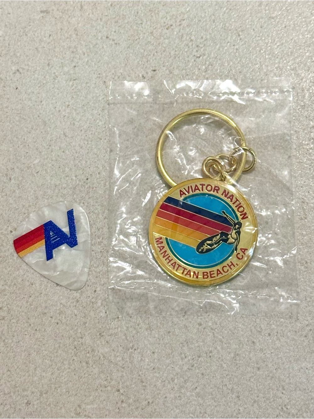 Aviator Nation Gold Enamel Keychain with Rainbow Stripes & AV Guitar Pick
